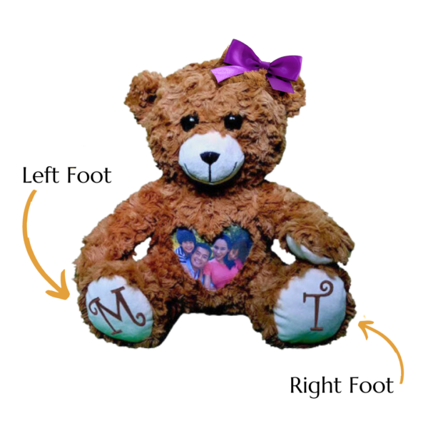 Personalized teddy bear with decals on feet.