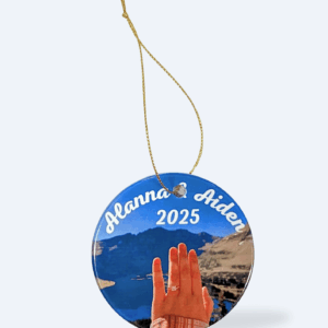 A photo of a customized circular ornament hanging on a gold thread against a white background.