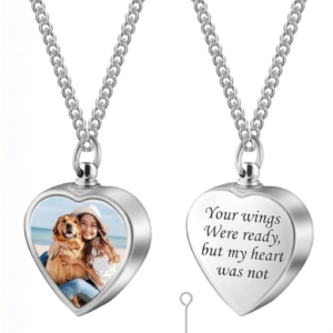 A photo of a heart shaped necklace with a girl and her dog on the frnot, and on the back the words "Your wings were ready, but my heart was not" is engraved. It also shows a funnel and macro pin tool against a white background.